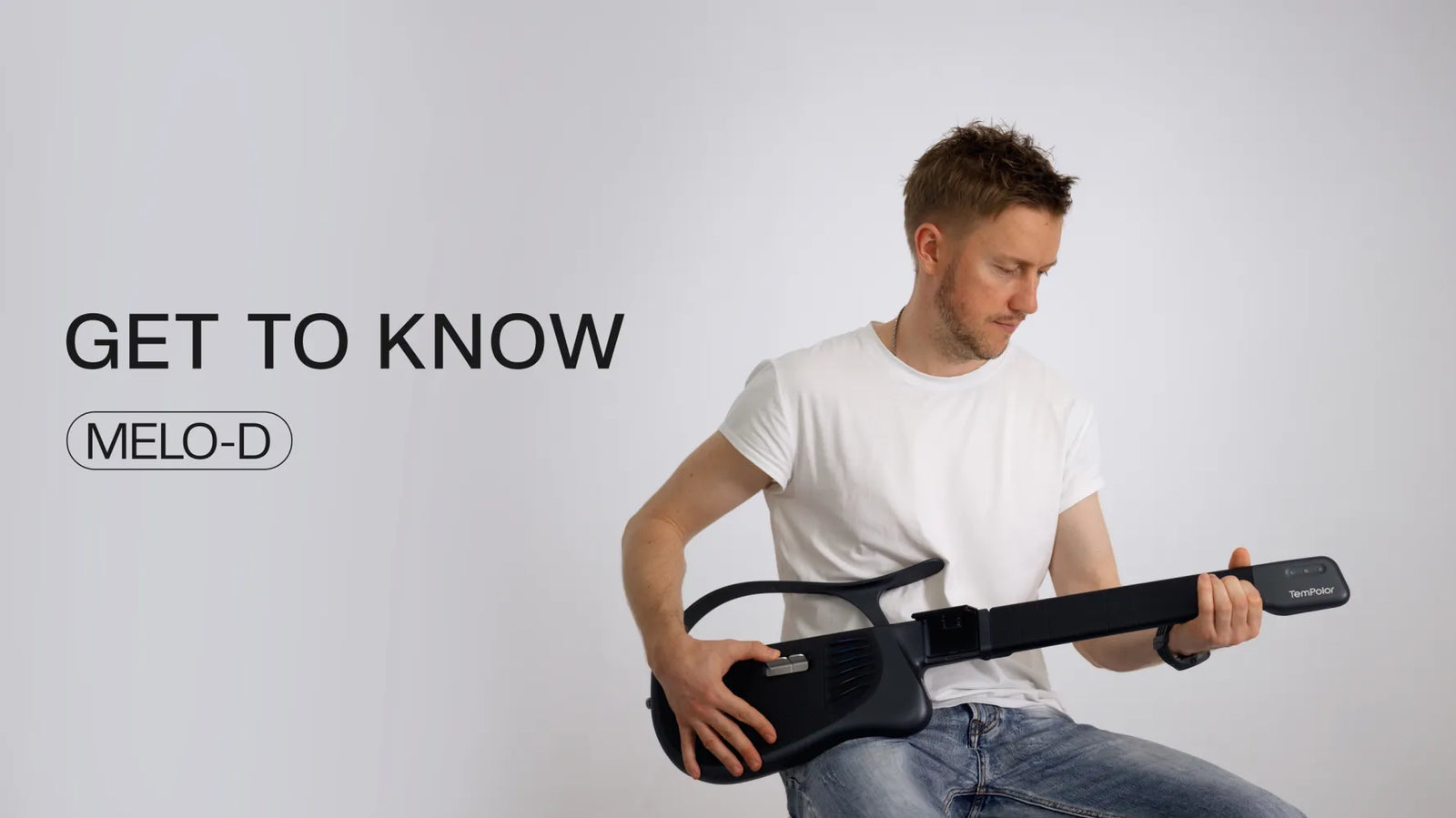 A musician playing the Melo-D guitar